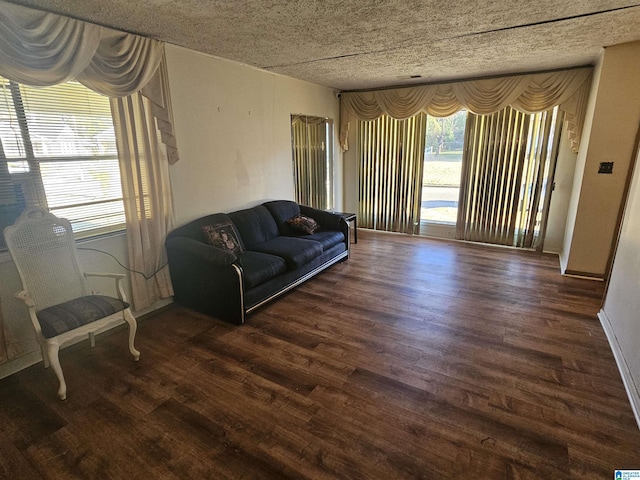 living room featuring dark hardwood / wood-style floors and a textured ceiling