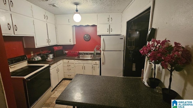 kitchen featuring white appliances, a textured ceiling, white cabinetry, light tile patterned floors, and sink