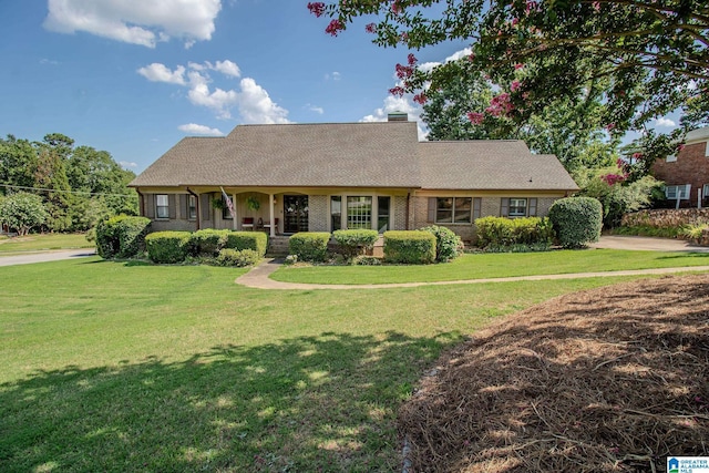 ranch-style house with a front yard and a porch