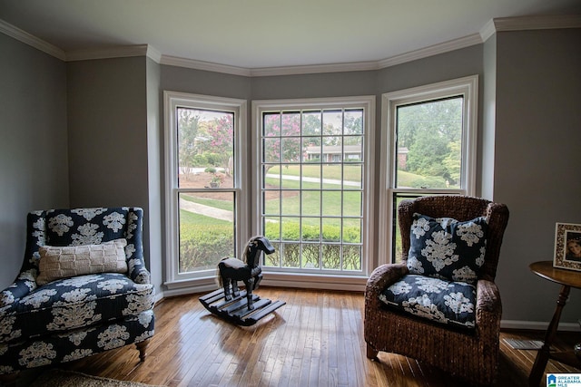 sitting room featuring hardwood / wood-style flooring, a wealth of natural light, and crown molding