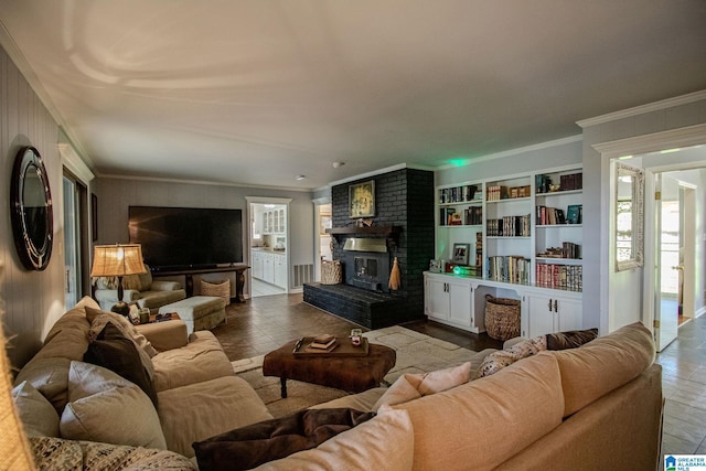 living room with crown molding and a fireplace