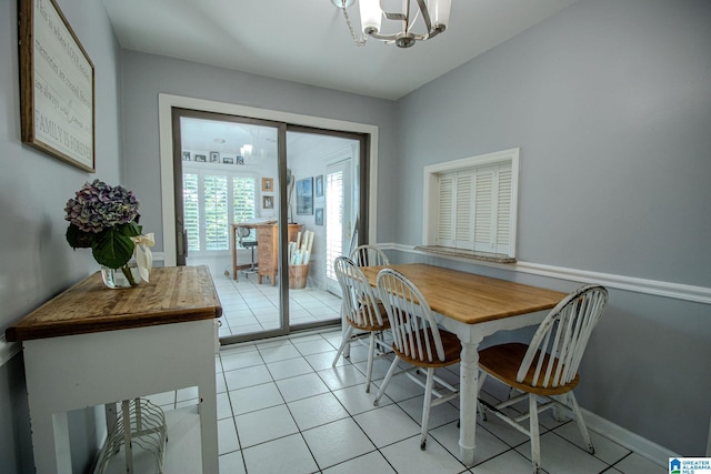 tiled dining space with an inviting chandelier