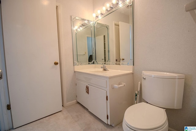 bathroom with toilet and vanity