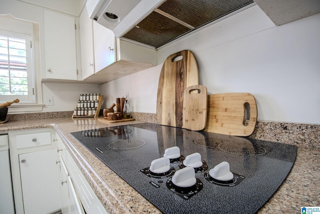 kitchen with white cabinetry, black electric cooktop, and extractor fan