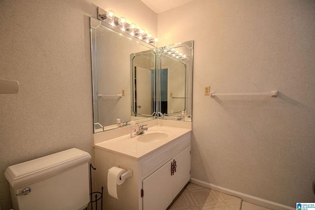 bathroom featuring toilet and vanity