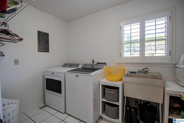 laundry room with light tile patterned flooring, electric panel, sink, and independent washer and dryer