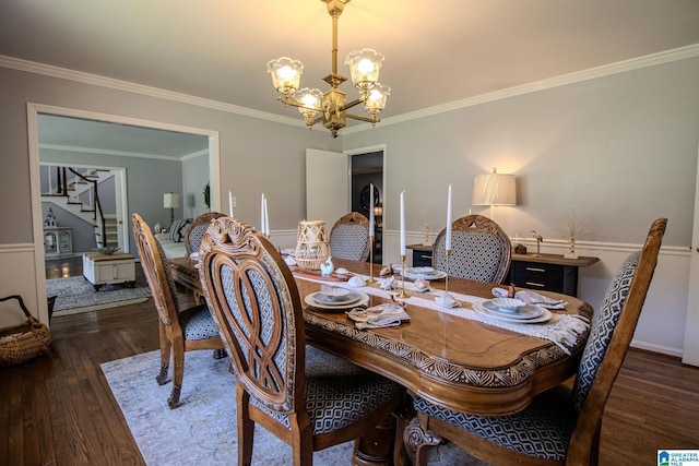 dining space with ornamental molding, an inviting chandelier, and dark hardwood / wood-style flooring