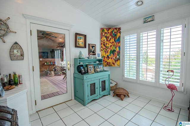 interior space with wood ceiling, vaulted ceiling, and light tile patterned floors