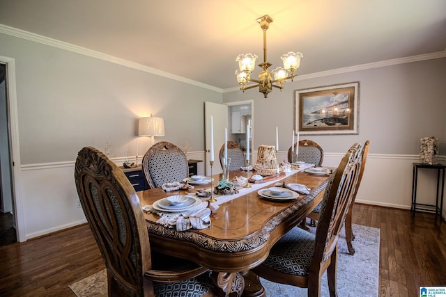 dining area with an inviting chandelier, dark hardwood / wood-style floors, and crown molding