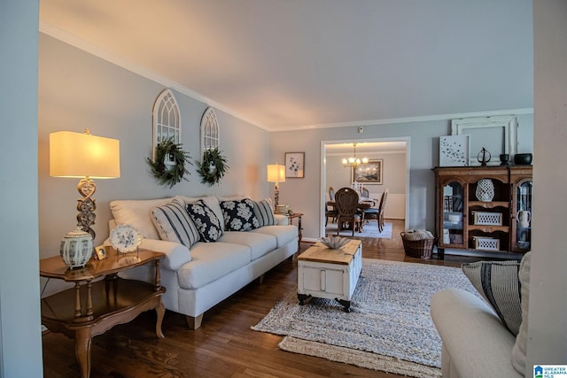 living room with dark hardwood / wood-style floors, crown molding, and a notable chandelier