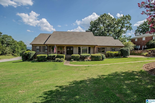 view of front of property with covered porch and a front lawn