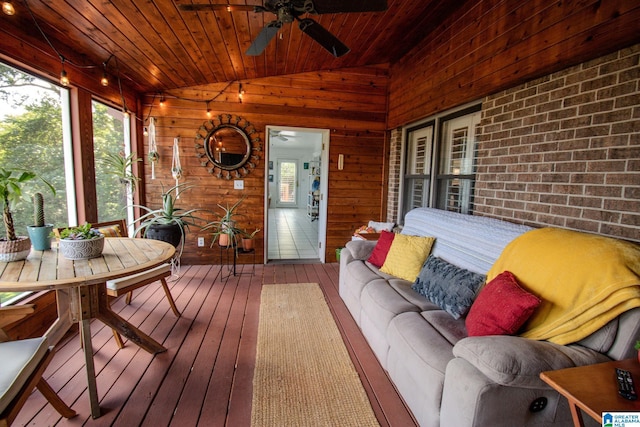 sunroom / solarium featuring wooden ceiling, vaulted ceiling, and ceiling fan