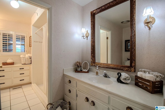 bathroom featuring tile patterned floors, vanity, and a shower with curtain