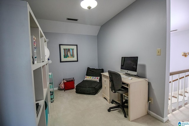 home office featuring light colored carpet and vaulted ceiling