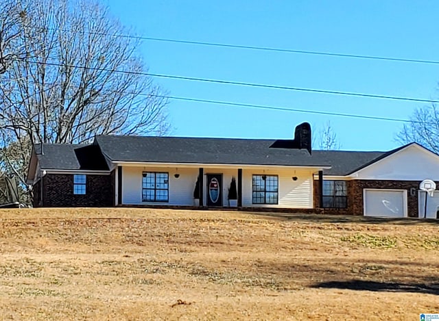 single story home with a garage and a front yard