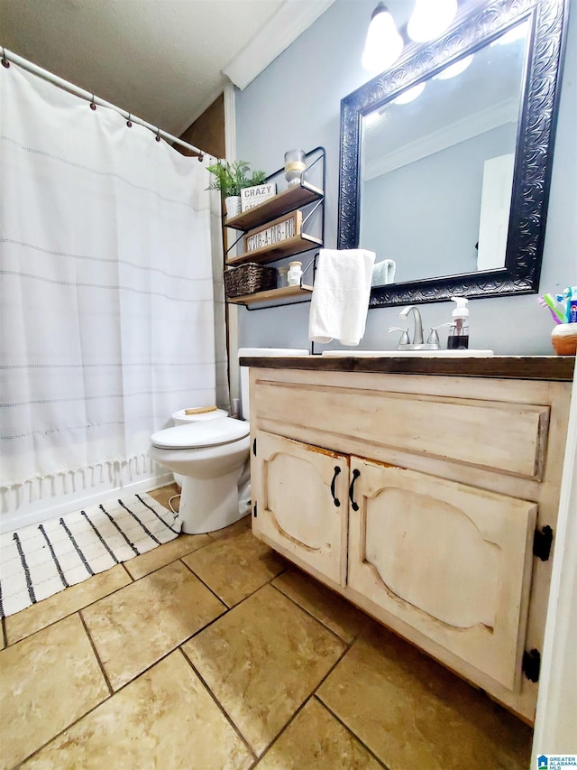 bathroom with vanity, ornamental molding, tile patterned floors, and toilet