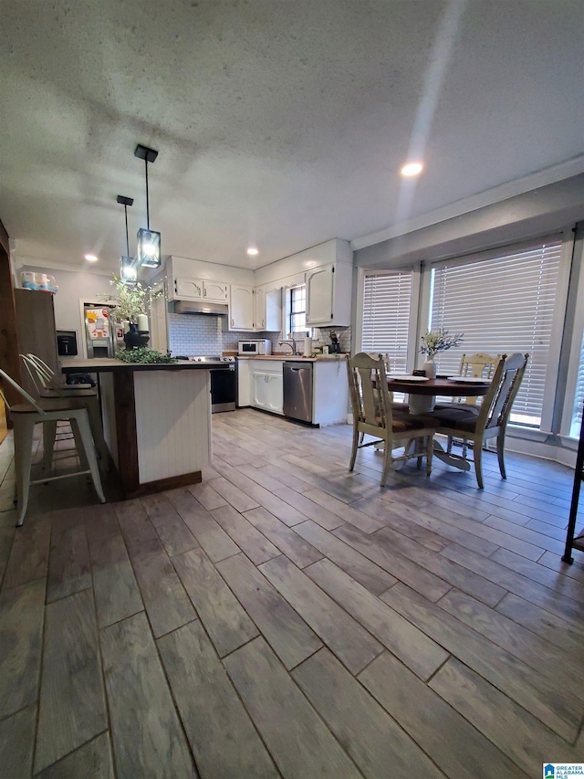 dining room featuring sink and a textured ceiling