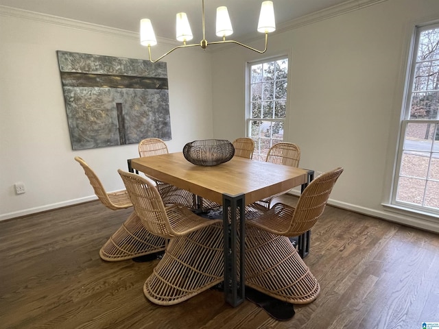 dining room with ornamental molding, dark hardwood / wood-style floors, and a chandelier