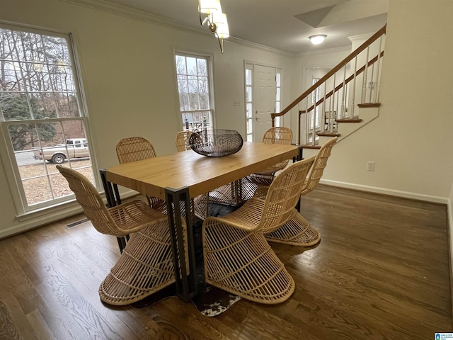 dining area featuring dark wood-type flooring and ornamental molding