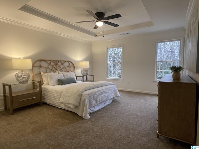 bedroom with crown molding, ceiling fan, a raised ceiling, and dark colored carpet