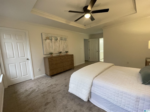 bedroom featuring a tray ceiling, ceiling fan, and carpet