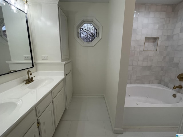 bathroom featuring tile patterned floors, vanity, and a tub