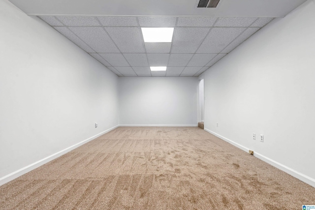 unfurnished room with carpet floors and a paneled ceiling