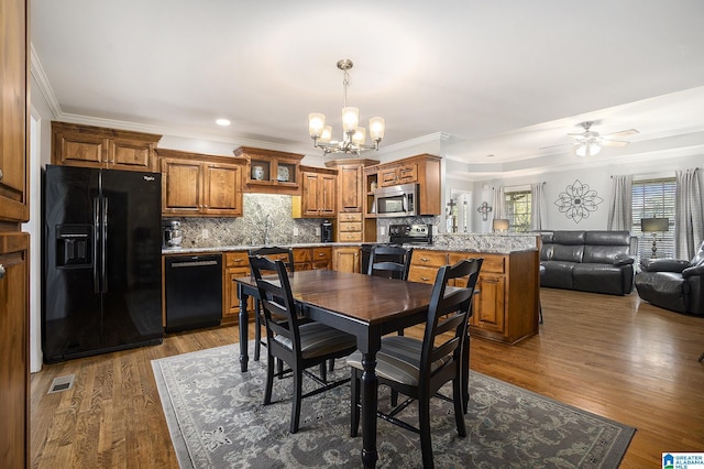 dining area with sink, dark hardwood / wood-style floors, and ornamental molding