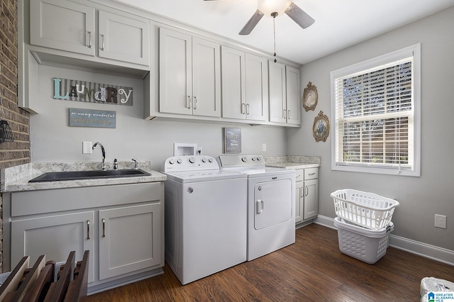 laundry area featuring sink, washing machine and dryer, ceiling fan, dark hardwood / wood-style floors, and cabinets