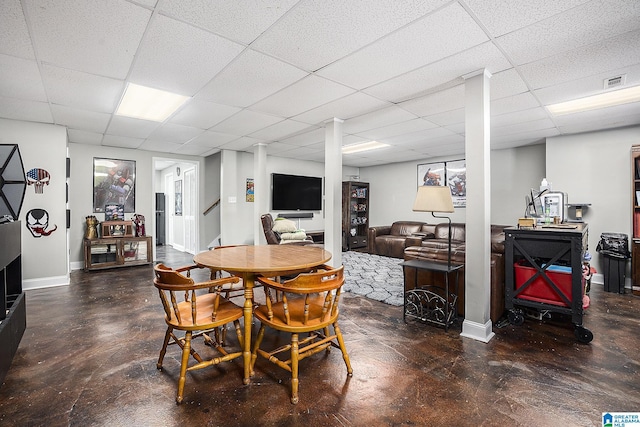 dining area with a paneled ceiling