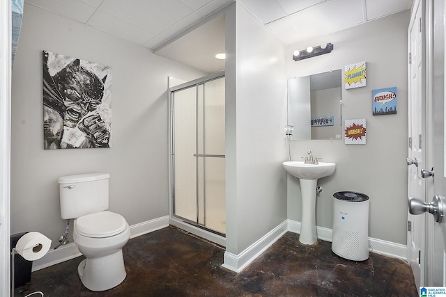 bathroom featuring concrete floors, sink, an enclosed shower, and toilet