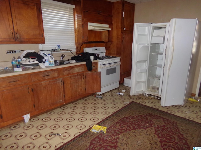 kitchen featuring sink and white appliances