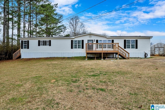 back of property with a wooden deck and a yard