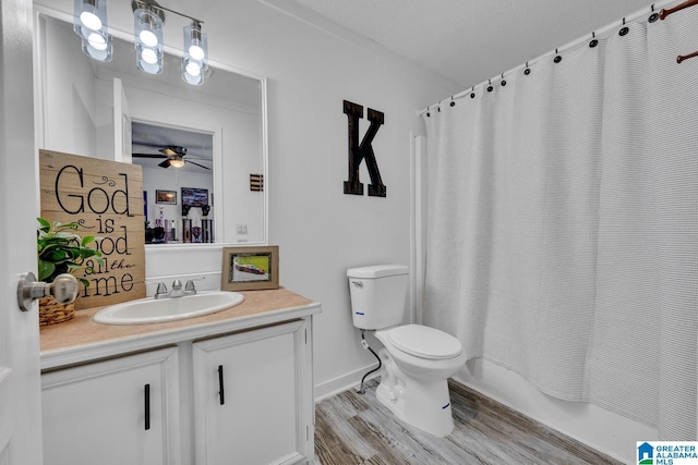 full bathroom featuring shower / bath combo, hardwood / wood-style flooring, toilet, and vanity