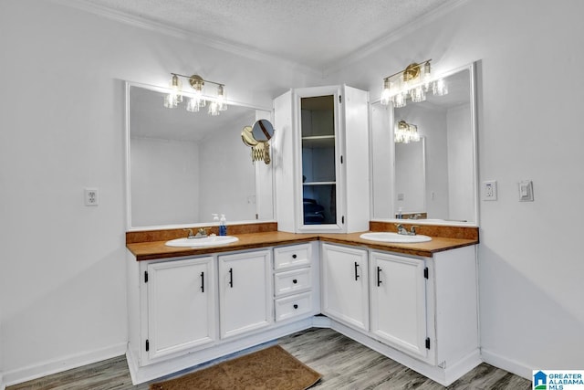 bathroom featuring wood-type flooring, a textured ceiling, and vanity