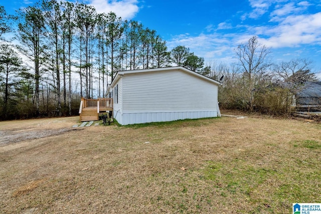 view of property exterior with a wooden deck and a lawn