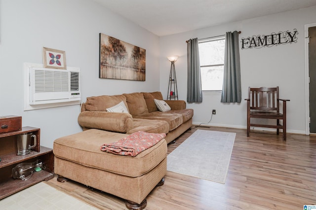 living room featuring hardwood / wood-style flooring and an AC wall unit