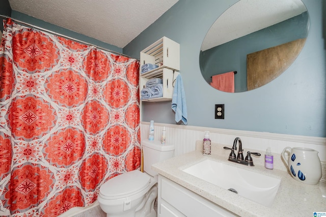 bathroom with vanity, a textured ceiling, and toilet