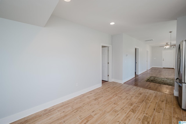 unfurnished room with light wood-type flooring and ceiling fan