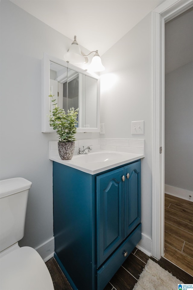 bathroom featuring toilet and vanity