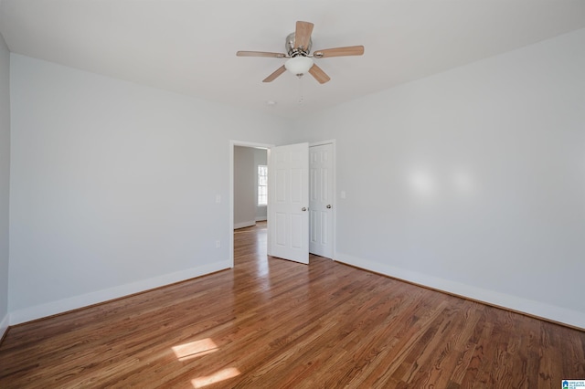 spare room featuring wood-type flooring and ceiling fan