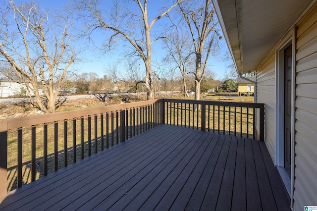 wooden terrace with a lawn