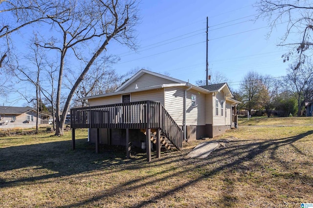 back of property with a deck and a lawn