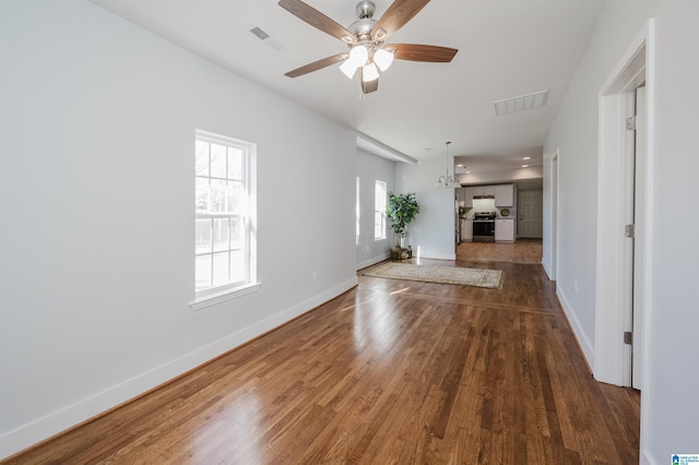 unfurnished living room with ceiling fan and dark hardwood / wood-style flooring