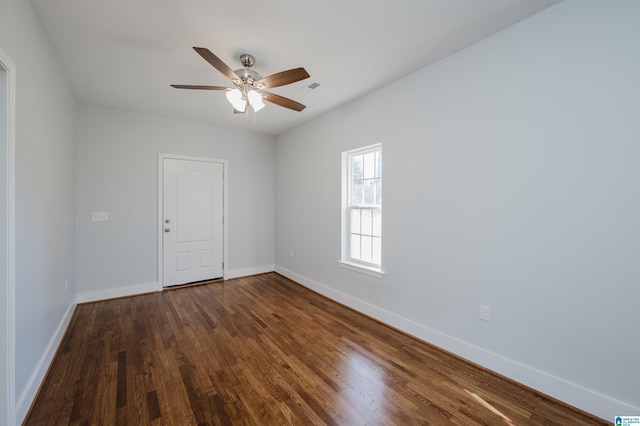 unfurnished room featuring ceiling fan and dark hardwood / wood-style floors