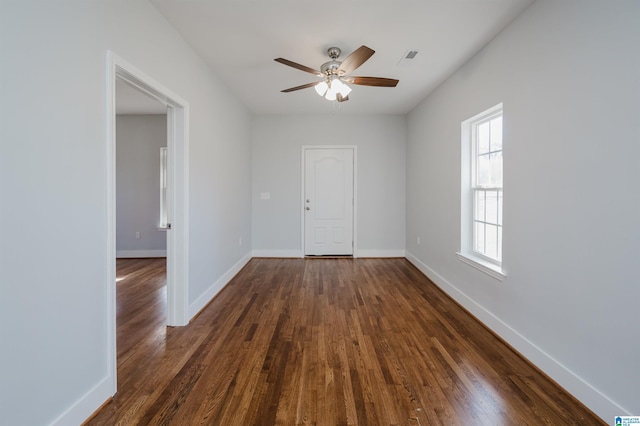 empty room featuring dark hardwood / wood-style floors and ceiling fan