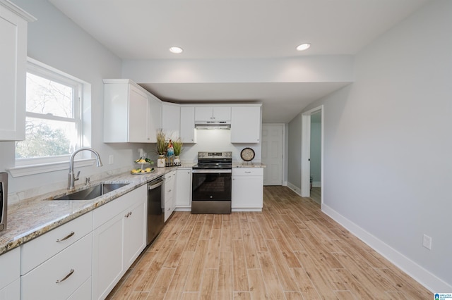 kitchen with light hardwood / wood-style flooring, sink, white cabinetry, light stone countertops, and stainless steel appliances