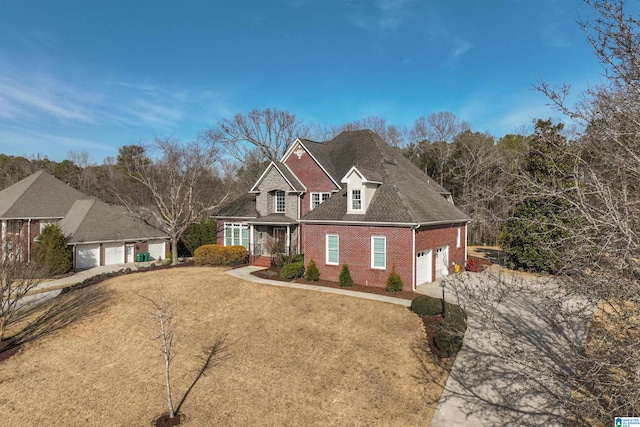 view of front of house with a garage, a front lawn, and a porch