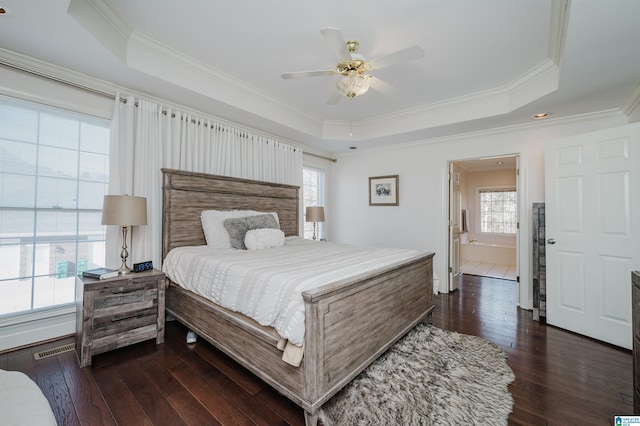 bedroom featuring a raised ceiling, ornamental molding, dark hardwood / wood-style floors, and ceiling fan