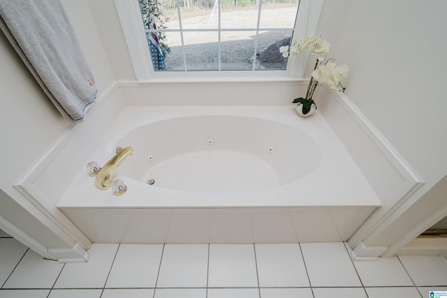 bathroom with tiled tub and tile patterned floors